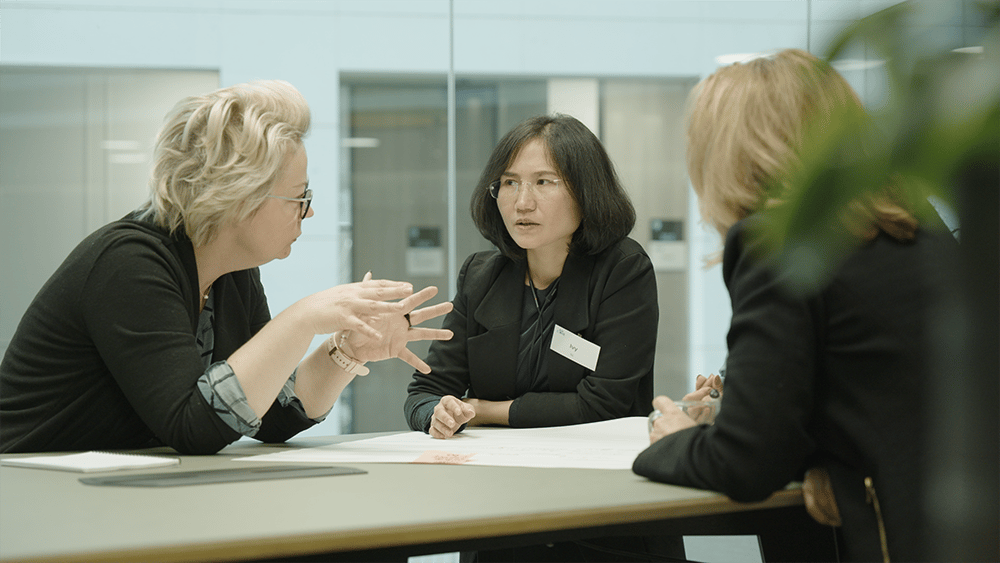 CEDR-3-Mediation-Professionals-Debate-at-a-tall-desk