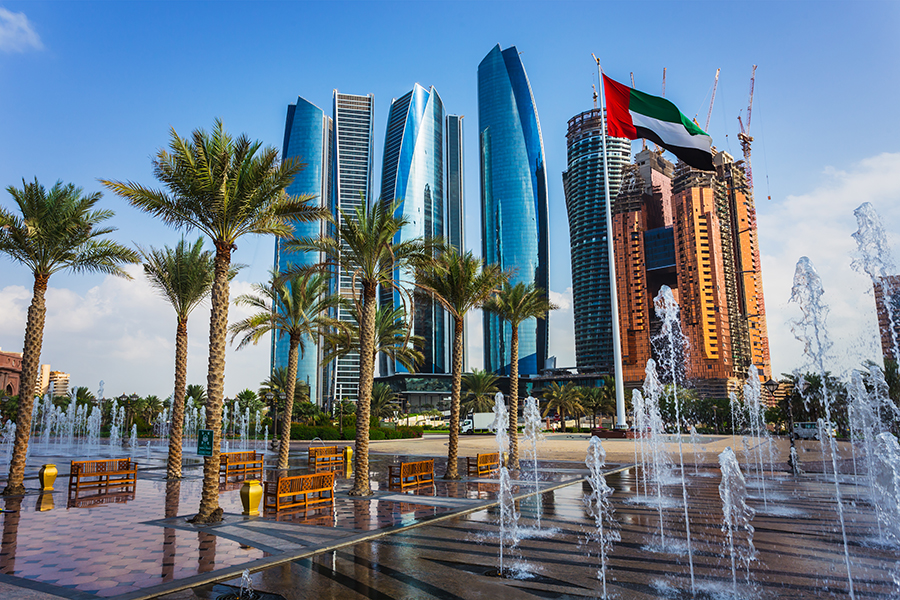 Dubai sky scrapers with flag and water fountain