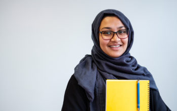Portrait photo of woman with yellow notepad