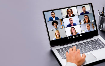 Laptop screen showing nine people